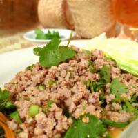 Larb Salad · Cooked ground meat which is tossed with lime juice, chili powder, fish sauce and toasted ric...