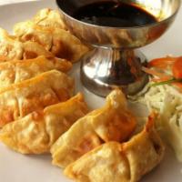 A6. Thai Dumpling · Deep minced chicken and vegetables stuffed in gyoza pocket and served with sweet sauce.