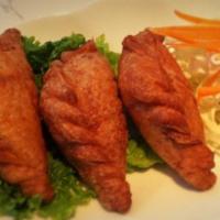 A8. Karee Puffs · Golden brown soft and crispy croissant bread filled with minced chicken, snow peas, potato a...