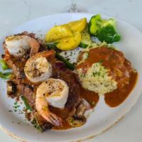 Surf and Turf · 12 oz grilled Angus New York strip and shrimps, cognac peppercorn sauce served with garlic m...