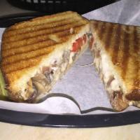 Philly Cheese Steak Panini · Steak, Swiss cheese, onions, mushrooms, green peppers and mayo. Made with your choice of fre...