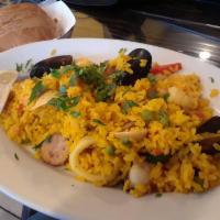 Paella de Mariscos · Seafood Spanish rice. Seafood mix, sausage, bell peppers, peas and yellow Spanish rice.