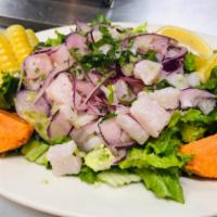 Ceviche de Pescado · Fish ceviche. Diced fish, red onions, sweet potato, Peruvian corn and lettuce.