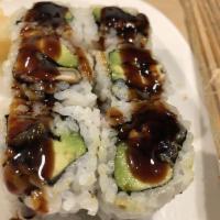 Eel Avocado Roll · Baked eel and avocado wrapped inside out with sesame seed with eel sauce on top