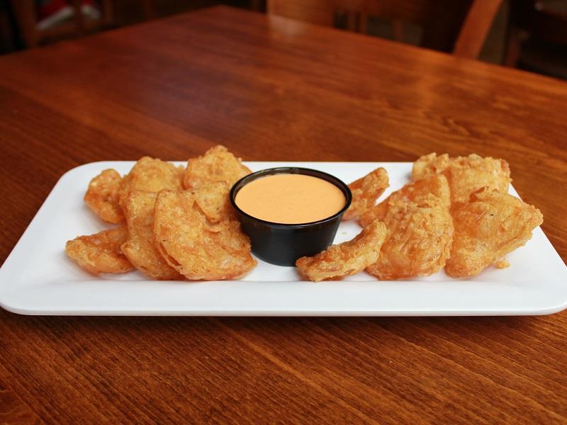 Onion Petals 3 Rd Prty · Hand cut and seasoned petals dipped in trickster IPA beer batter and served with house-made Sriracha aioli.