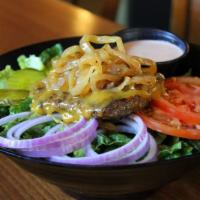 Cheeseburger Bowl Salad · Fresh romaine lettuce tossed in our salsa ranch dressing. Topped with a Painted Hills fresh ...