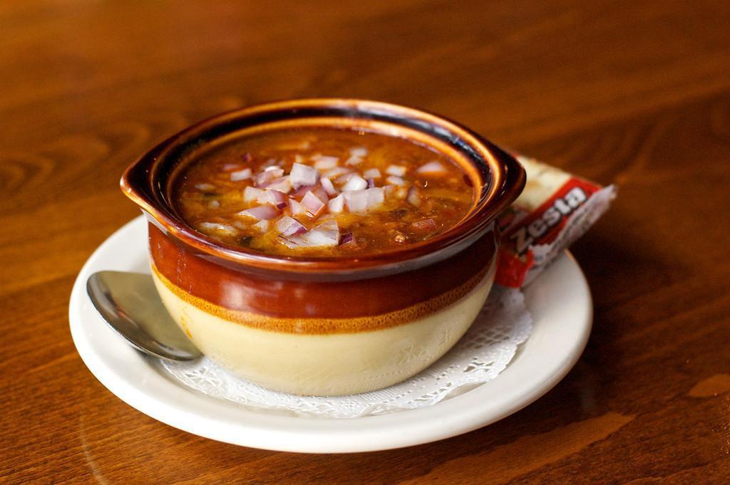 Outlaw Chili · House made spicy chili. Served with shredded cheddar, chopped onion, or sour cream on request.