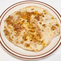 Keema Naan · Leavened bread stuffed with mildly spiced minced lamb, baked in the tandoor.