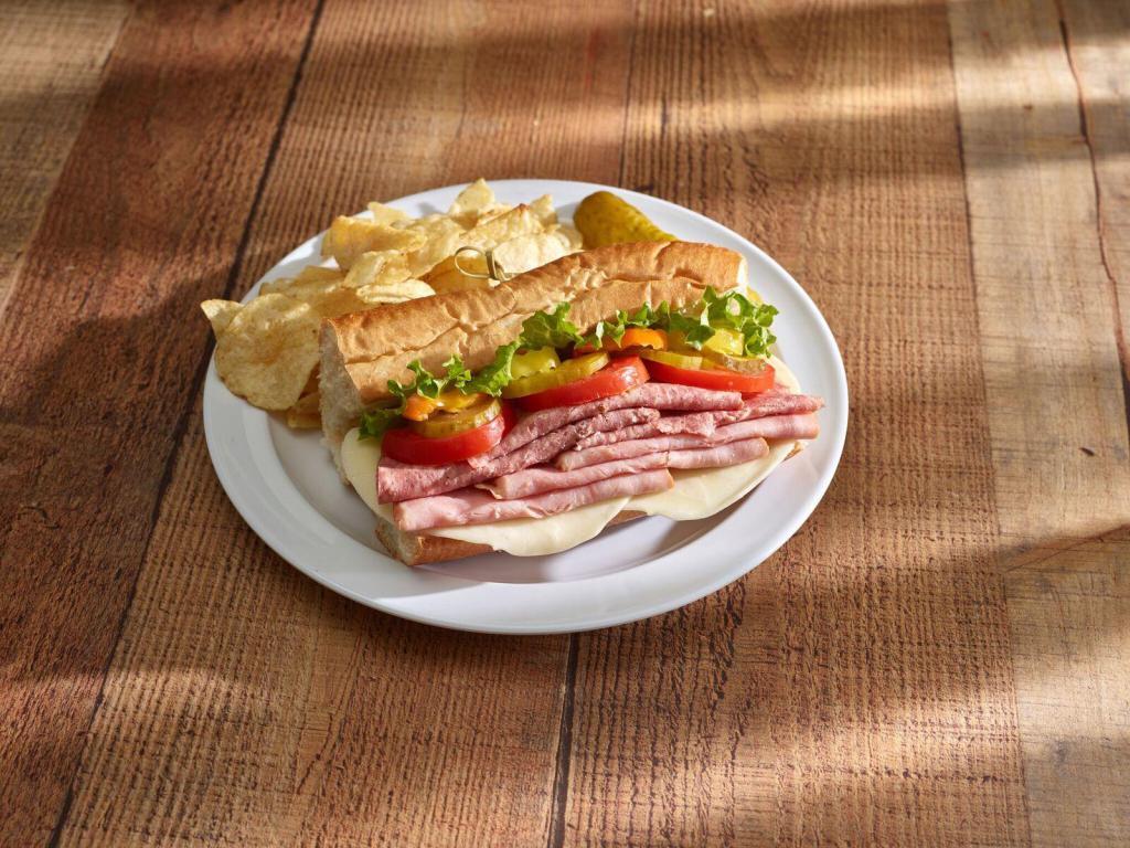 Combo Sub · Ham, salami and cheese. Served with lettuce, onions, tomatoes, pickles, peppers, cheese, Italian dressing, pickle spear and chips.