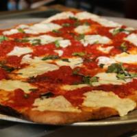 Brooklyn Pizza · Thin crust square pizza with chunks of tomato, fresh mozzarella, basil, and olive oil.