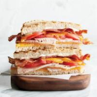 Club Panini · Oven-roasted turkey, bacon, cheddar, tomato, mayonnaise, grilled sourdough.