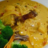 43. Duck Curry · Sliced of roasted duck served with red curry sauce, tomatoes, green peas, pineapples, basil ...
