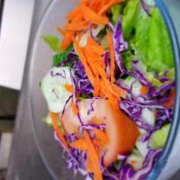 Garden Salad · Romaine salad with tomatoes, cabbage, cucumbers, carrots and dressing on the side. 