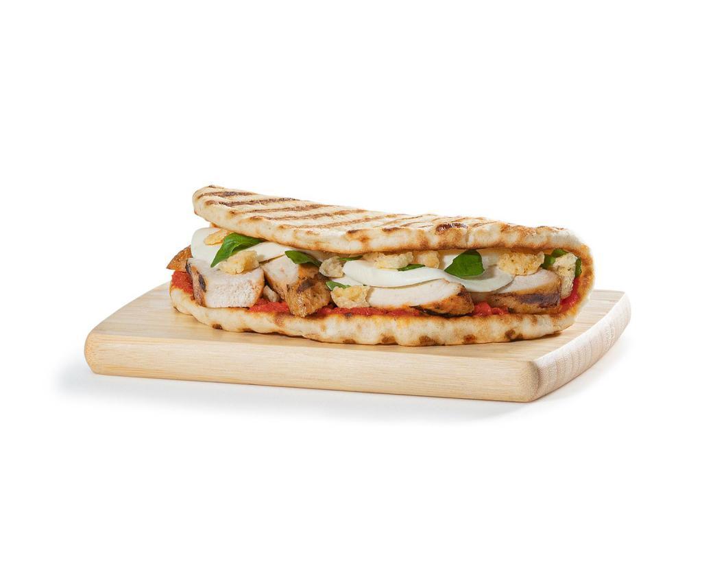 Chicken Parma Flatbread · Grilled chicken, fresh mozzarella, Parmesan crisps, slow-roasted tomato spread and fresh basil on a flatbread. Includes a choice of side: chips, whole fruit, or kale & apple slaw.