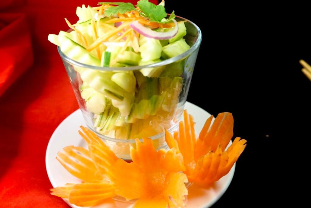 Cucumber Salad · Fresh sliced cucumber, carrots and red onions with Thai sweet and sour dressing. Vegetarian.