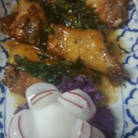 9. Spicy Angel Wings · Deep fried chicken wings with sweet and sour tamarind sauce topped with crispy basil leaves....