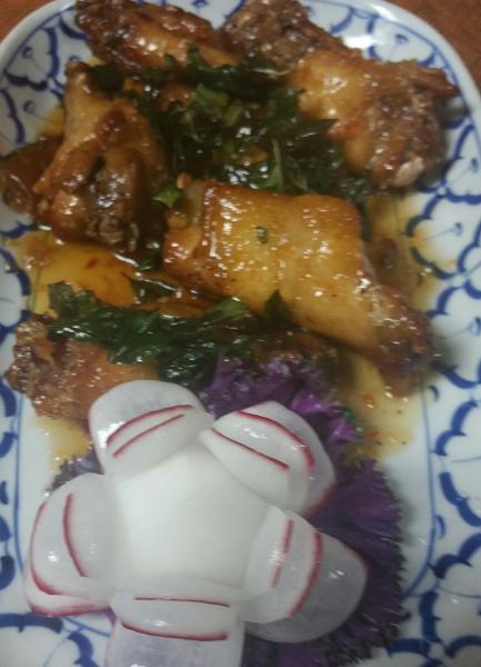 9. Spicy Angel Wings · Deep fried chicken wings with sweet and sour tamarind sauce topped with crispy basil leaves. Spicy