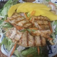 18. Salmon Mango Salad · Fresh grilled salmon on a bed of field greens, fresh mangoes, onions and toasted cashew nuts...