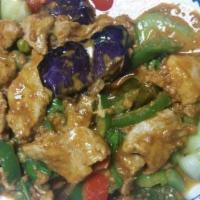 51. Spicy Pork with Eggplant · Sauteed pork with Prik Khing curry sauce, capers, lemon leaves, green peas, bell peppers and...