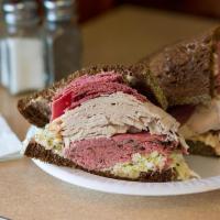 Sloppy Joe Sandwich · Hot corned beef, fresh turkey breast, fresh roast beef imported swiss coleslaw and Russian d...