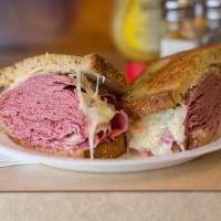 The Overstuffed Reuben Sandwich · Hot corned beef, sauerkraut and Swiss with Russian dressing. Served with coleslaw and a fres...