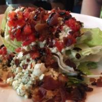 Iceberg Wedge Salad · Creamy blue cheese dressing, crispy bacon, blue cheese crumbles, Romano cheese, tomatoes and...