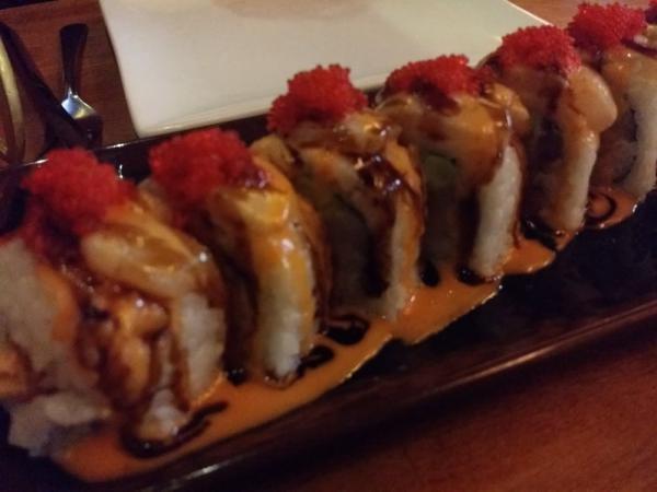 Wolfpack Roll · Shrimp tempura, yellowtail and avocado topped with seared scallops, red tobiko, spicy mayo and eel sauce.