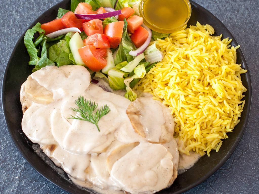 Kafta Be Tahini · Ground beef and lamb mixed with minced onion and herbs served on a hot plate topped with potatoes and cooked tahini sauce. Comes with rice and salad. Add additional side Greek salad for an additional charge.