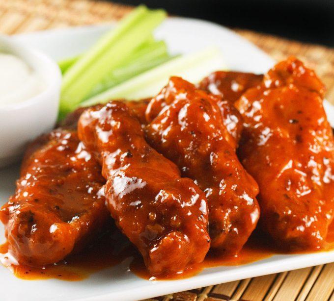 7 Piece Buffalo Chicken Wings · A Buffalo wing in American cuisine is an unbreaded chicken wing section that is generally deep-fried and then coated or dipped in a sauce consisting of a vinegar-based cayenne pepper hot sauce and melted butter prior to serving.
