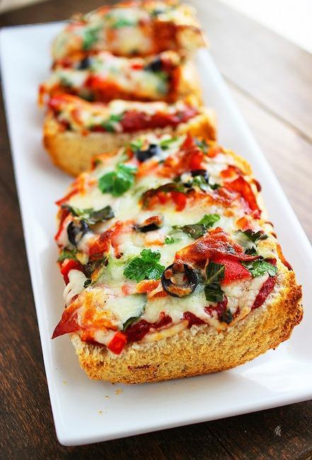 Garlic Bread Mozzarella Bruschetta · Topped with sliced tomatoes, garlic, basil, and melted mozzarella.