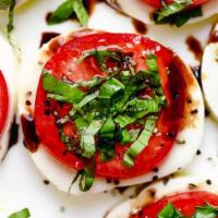 Mozzarella Caprese · Mozzarella and tomato served with fresh basil and sliced red peppers drizzled with extra vir...