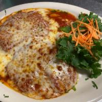 Chicken Parmigiana · Breaded breast of chicken cutlet topped with tomato sauce and mozzarella cheese. Served with...