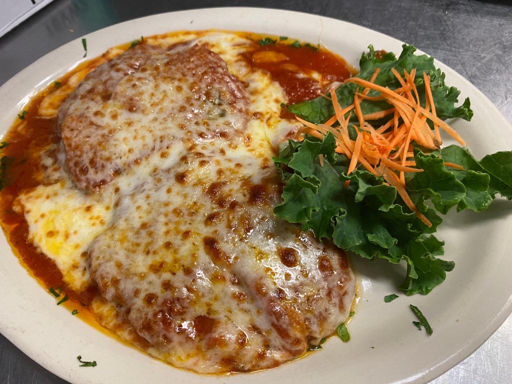 Chicken Parmigiana · Breaded breast of chicken cutlet topped with tomato sauce and mozzarella cheese. Served with vegetables of the day.