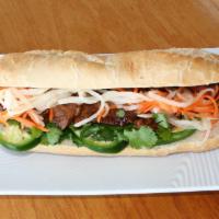 Meat Sandwich · Toasted French baguette with choice of meat, cilantro, pickled radish, carrot, cucumbers and...