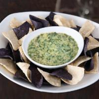 Spinach Artichoke Dip · Served hot with housemade blue and white corn tortilla chips. Vegetarian.
