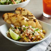 Mexican Street Corn · Roasted with smoked paprika, feta and Parmesan. Served with fresh cilantro, lime housemade r...