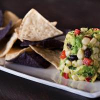 White Corn Guacamole and Chips Plate  · Diced avocado, sweet corn, black beans, jicama, bell peppers, fresh cilantro, and Serrano pe...