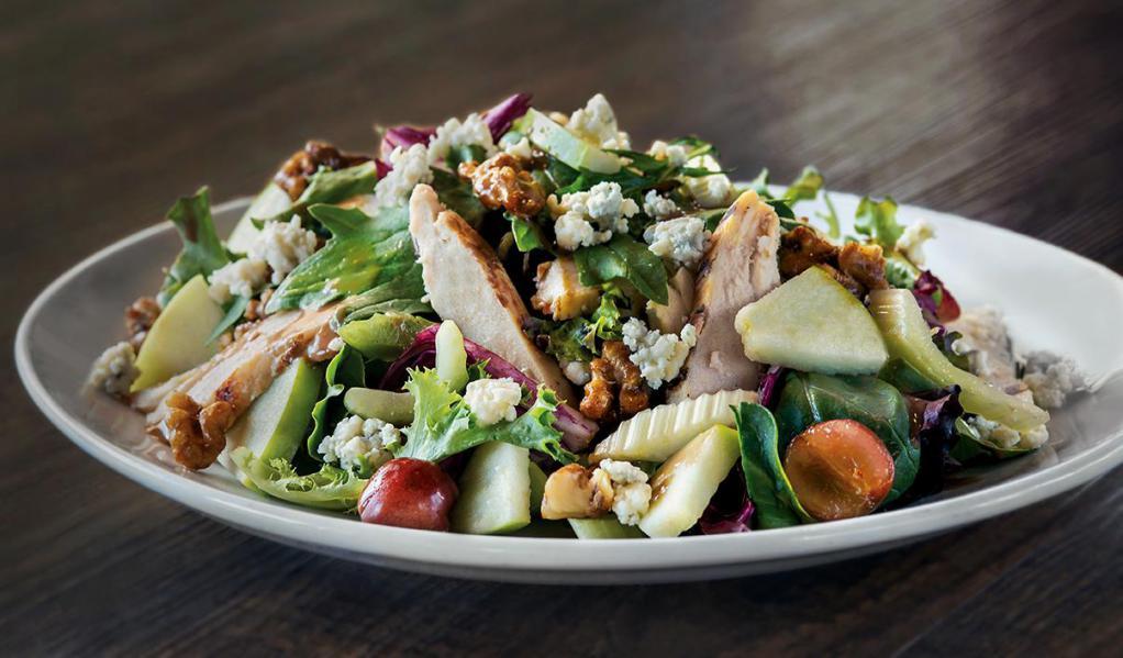 Waldorf Chicken Salad · Grapes, green apples, candied walnuts, crisp celery, baby greens, and Gorgonzola served with housemade Dijon balsamic vinaigrette. Gluten-free ingredients.