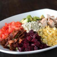 California Cobb Salad · Nueske's applewood smoked bacon, avocado, chicken, tomatoes, chopped egg, fresh basil, and G...