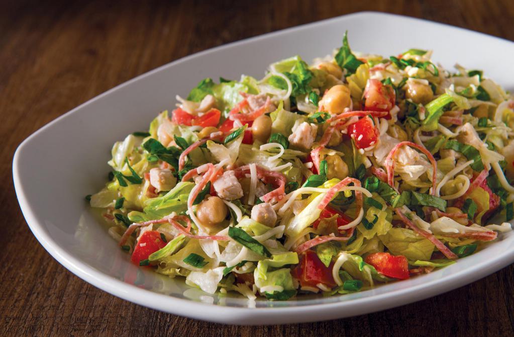 Italian Chopped Salad · Roasted turkey breast, julienned salami, garbanzo beans, tomatoes, mozzarella and fresh basil tossed in housemade mustard herb vinaigrette. Gluten-free ingredients.