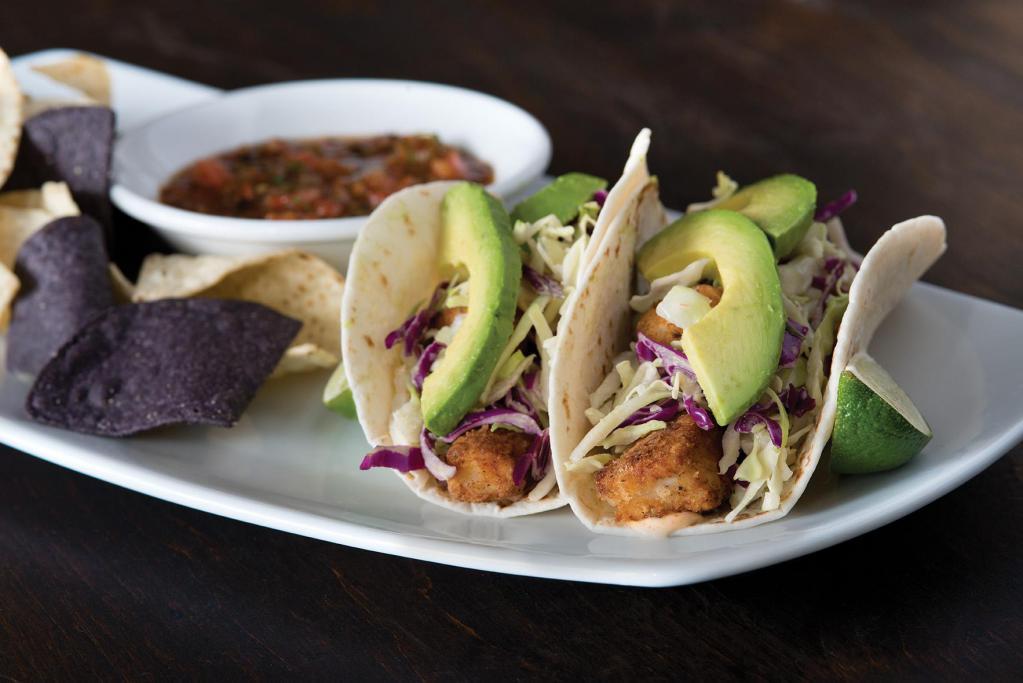 Crispy Fish Tacos  · Panko-crusted filleted white fish, fresh avocado, shaved cabbage, ranchito sauce and fresh cilantro wrapped in your choice of flour-corn tortillas or lettuce cups. Served with flame-roasted salsa and our housemade blue & white corn tortilla chips.