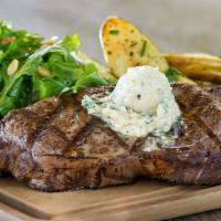 Fire-Grilled Ribeye · 12 oz. USDA choice ribeye grilled with housemade Pinot Noir sea salt and topped with blue ch...
