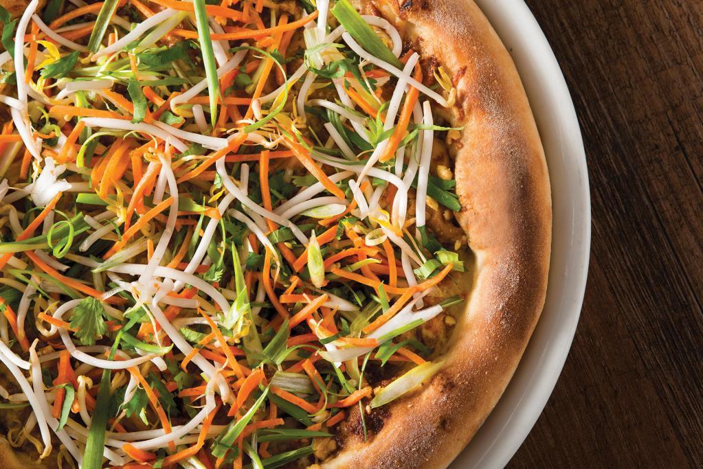 Thai Chicken Pizza · Thai peanut sauce and mozzarella, hearth-baked then topped with crisp bean sprouts, julienned carrots, slivered scallions and fresh cilantro.