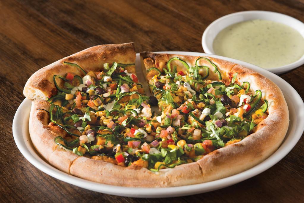 Spicy Chipotle Chicken Pizza  · Chipotle adobo sauce, shaved Poblanos and Monterey Jack with housemade roasted corn and black bean salsa, fresh cilantro and tangy lime crema.