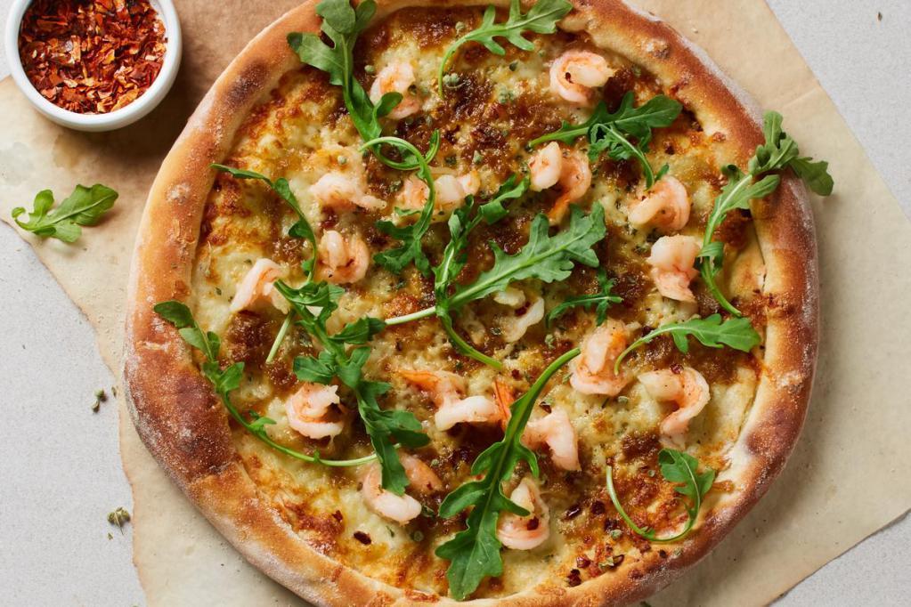 Shrimp Scampi Pizza  · Housemade lemon-garlic shrimp with caramelized onions, mozzarella, Parmesan and red chili, topped with fresh arugula and wild Greek oregano.