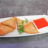 Vegetarian Samosa · Flour turnover filled with potatoes, red onions, peas, carrots and a blend of unique spices ...