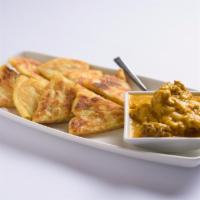Appetizer Palata · Multi-layer bread served with Coconut Chicken. (Sub Vegetarian Curry $2, Sub Lamb Curry $3)
