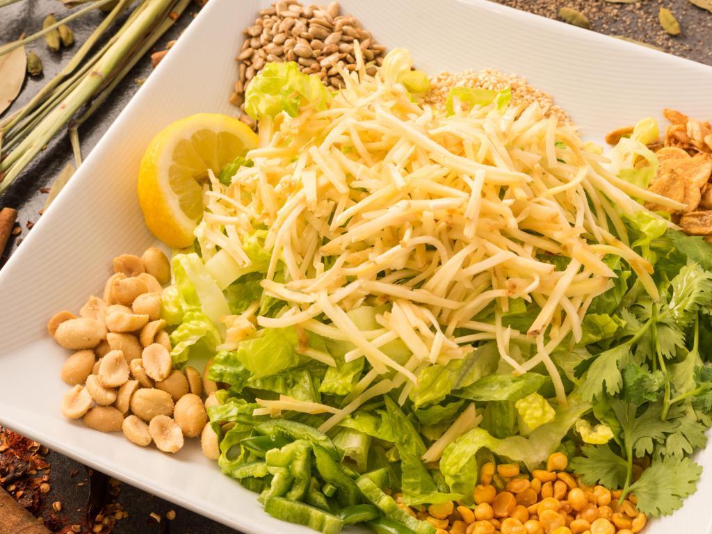 Ginger Salad · Light and refreshing; this salad is mixed with pickled ginger, fried garlic, yellow beans, sesame seeds, sunflower seeds, peanuts, jalapenos and dried shrimp. Vegetarian option available.