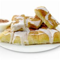 Cinnastix · Freshly Baked Breadsticks Topped with Butter, Cinnamon, Sugar & Icing