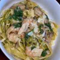 Shrimp Fettuccine · Egg and spinach noodles tossed with garlic shrimp, mushrooms, red onion, spinach blended wit...